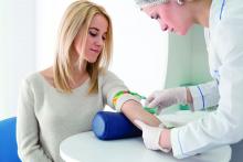 A health care provider prepares a patient for a blood test